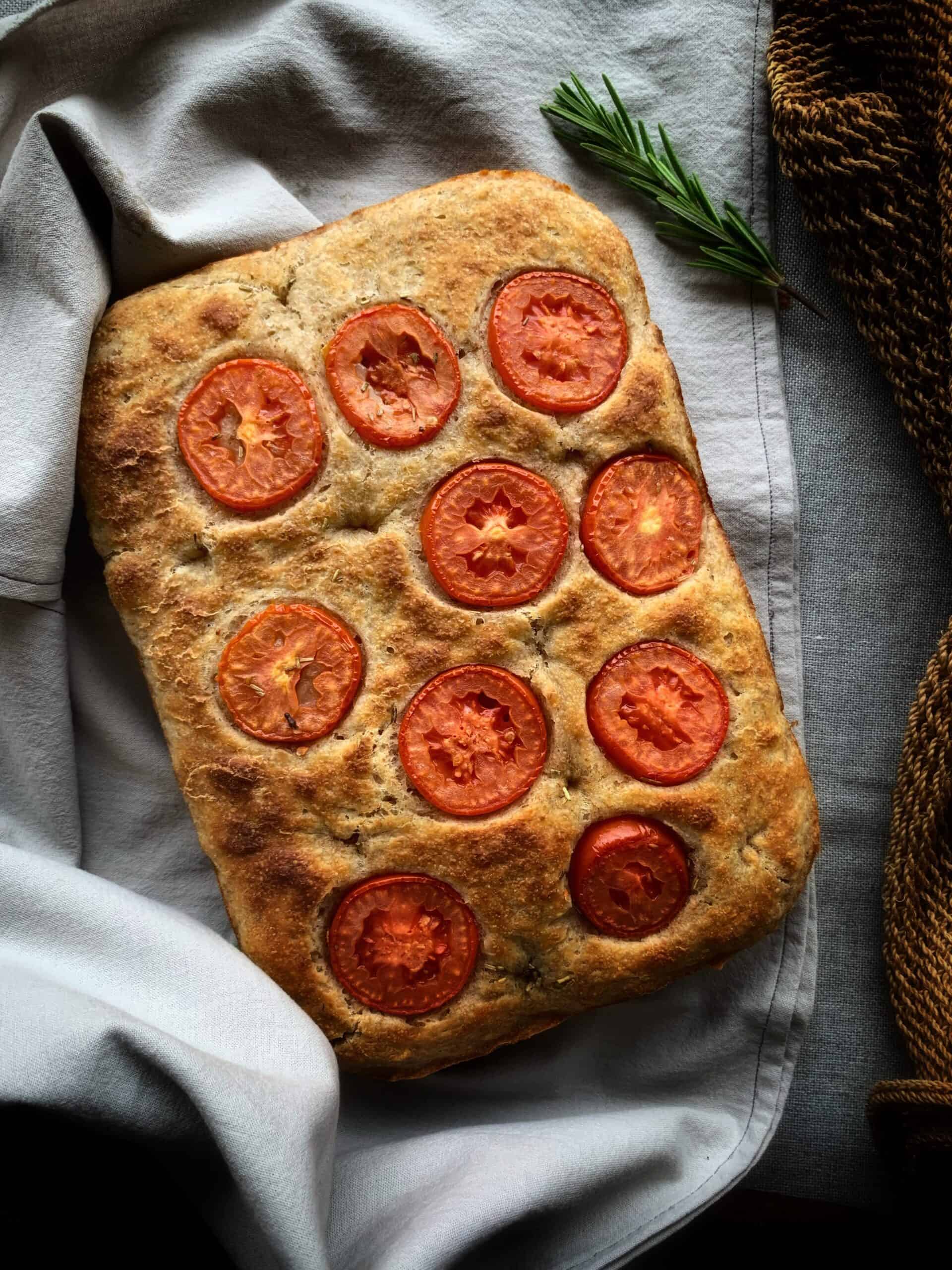 focaccia bread with sliced tomatoes on top