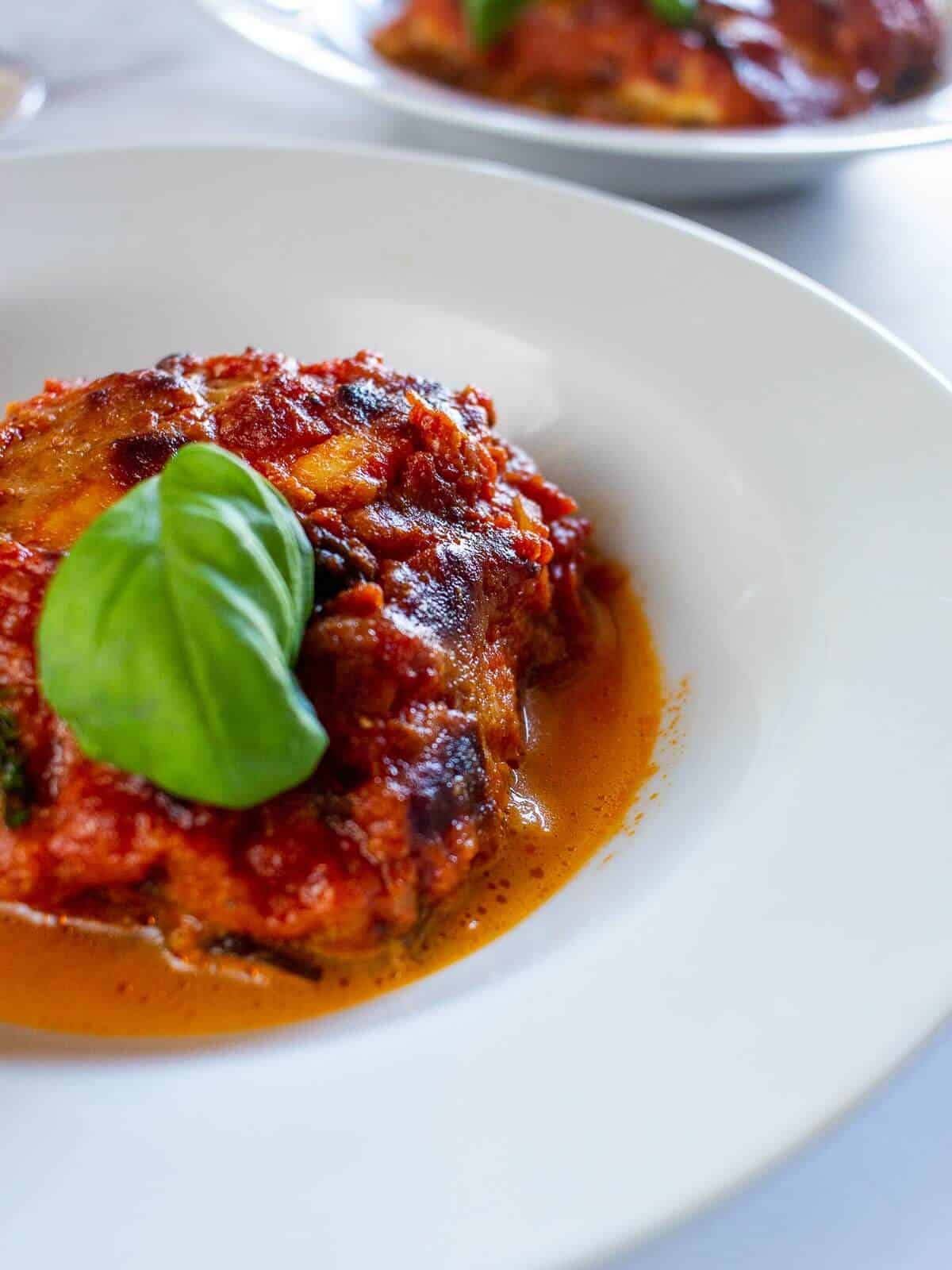 eggplant parmesan portion in a whiter plate.