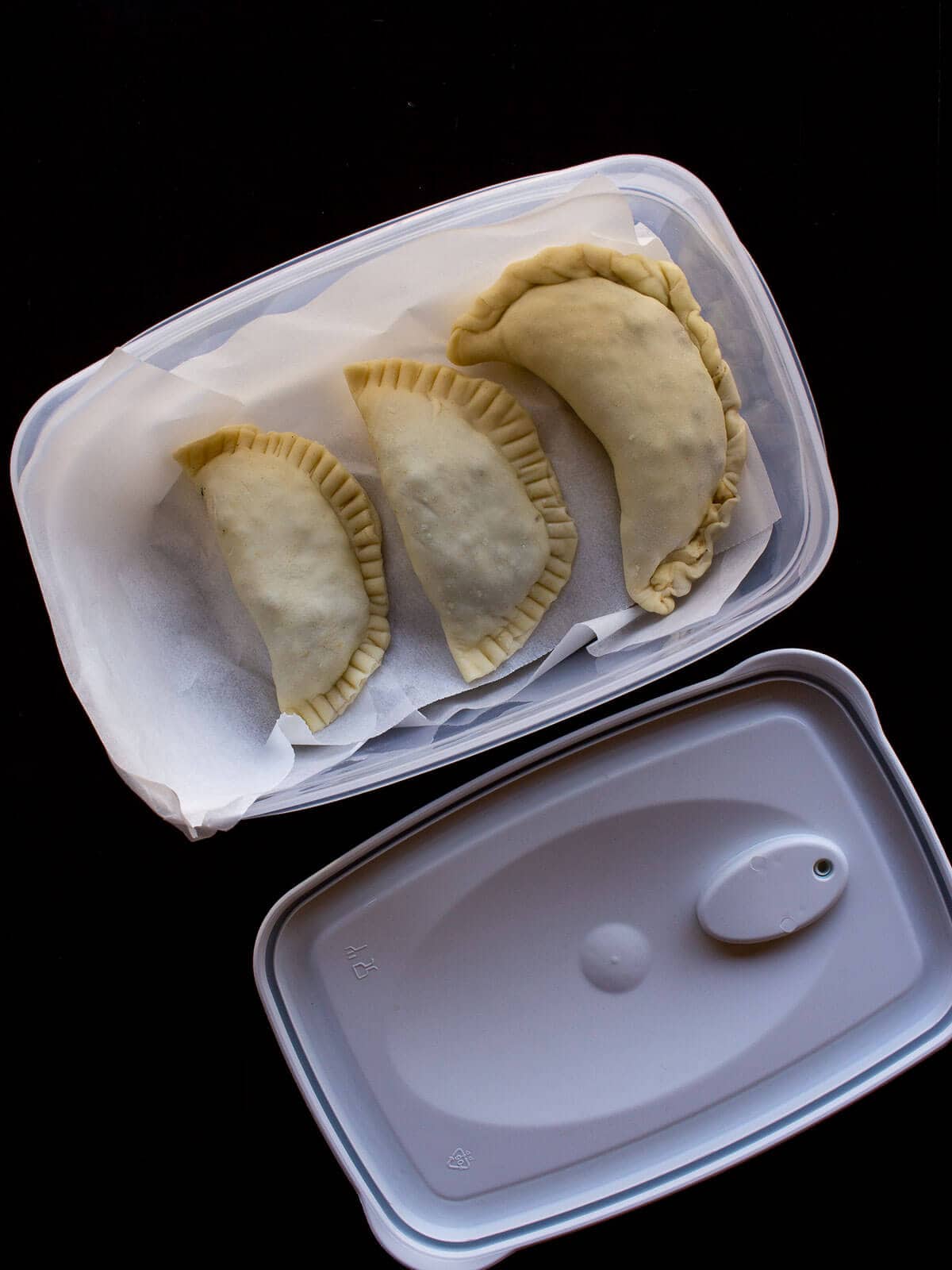 Ready to freeze empanadas, using an airtight container.