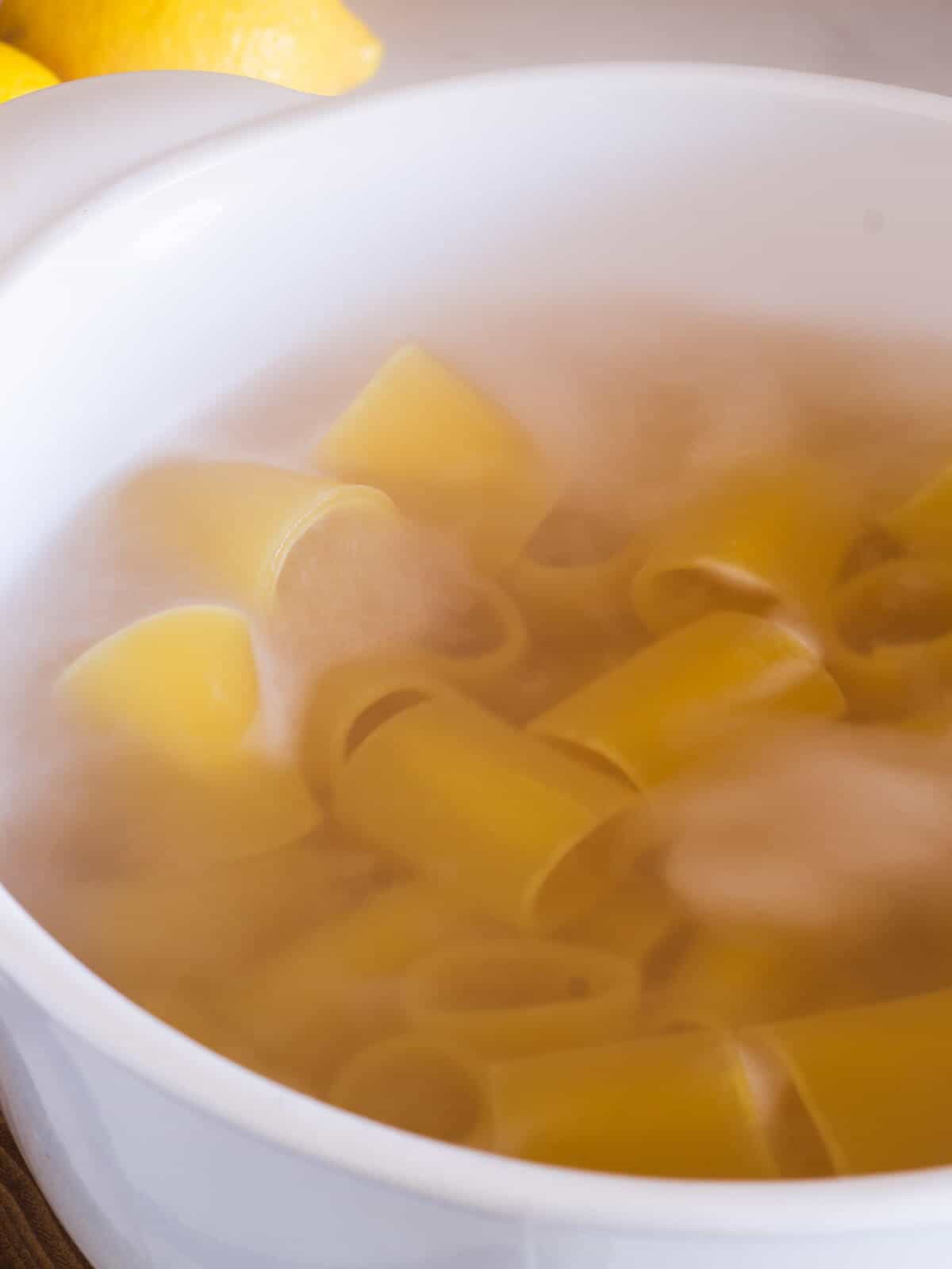 paccheri short pasta cooking in boiling water
