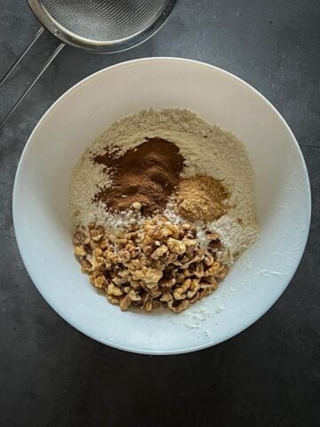 mixing walnuts and dry ingredients.