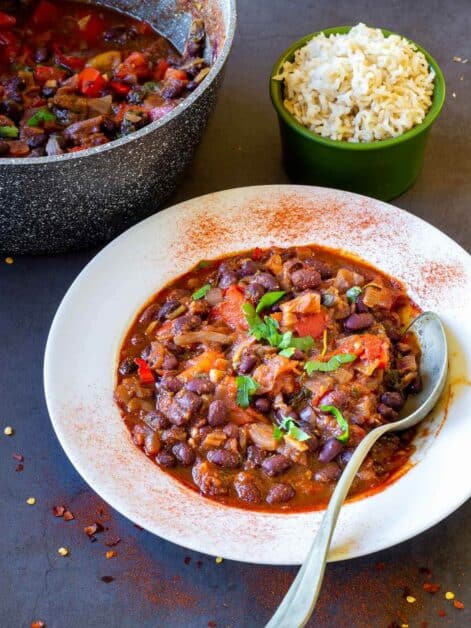 vegan chili served in white plate next to a pot