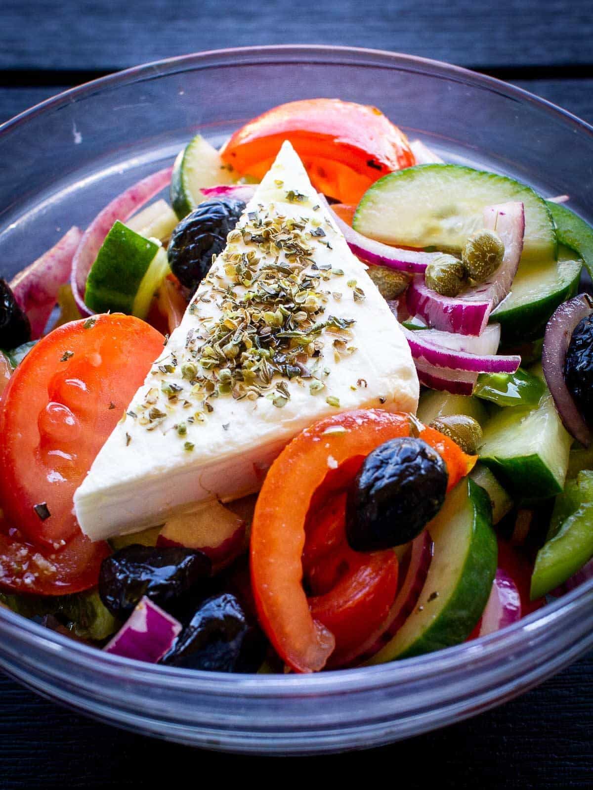 vegan greek salad in a glass bowl