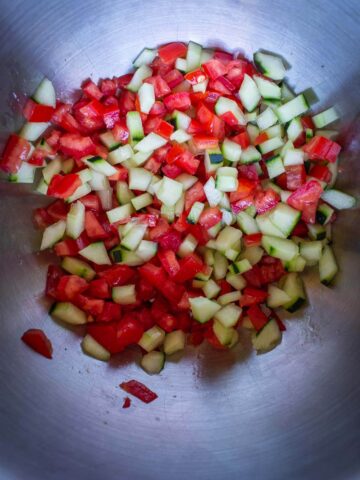 diced tomato and cucumber with salt in a bowl to remove excess water.