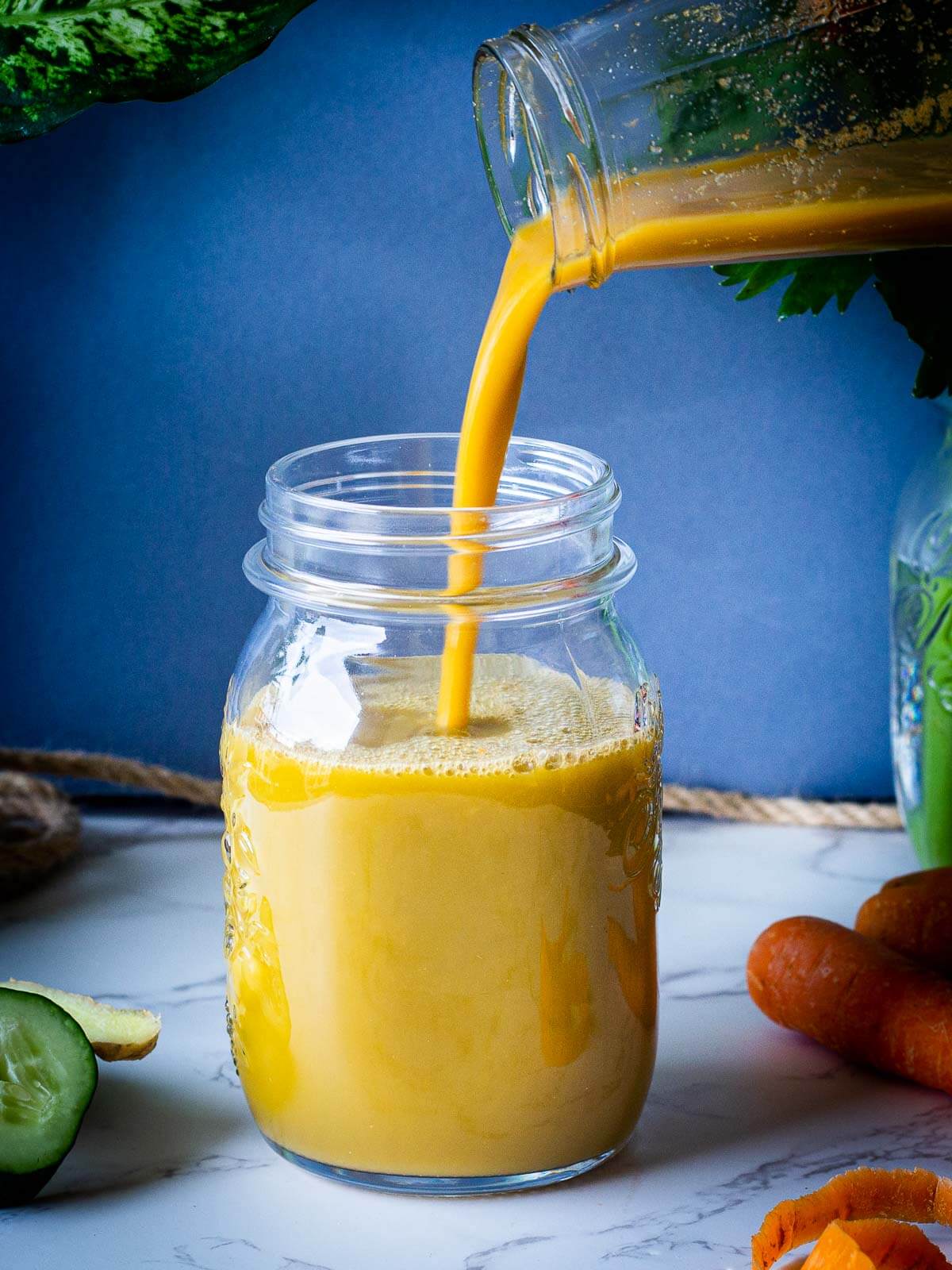 pouring carrot celery cucumber juice