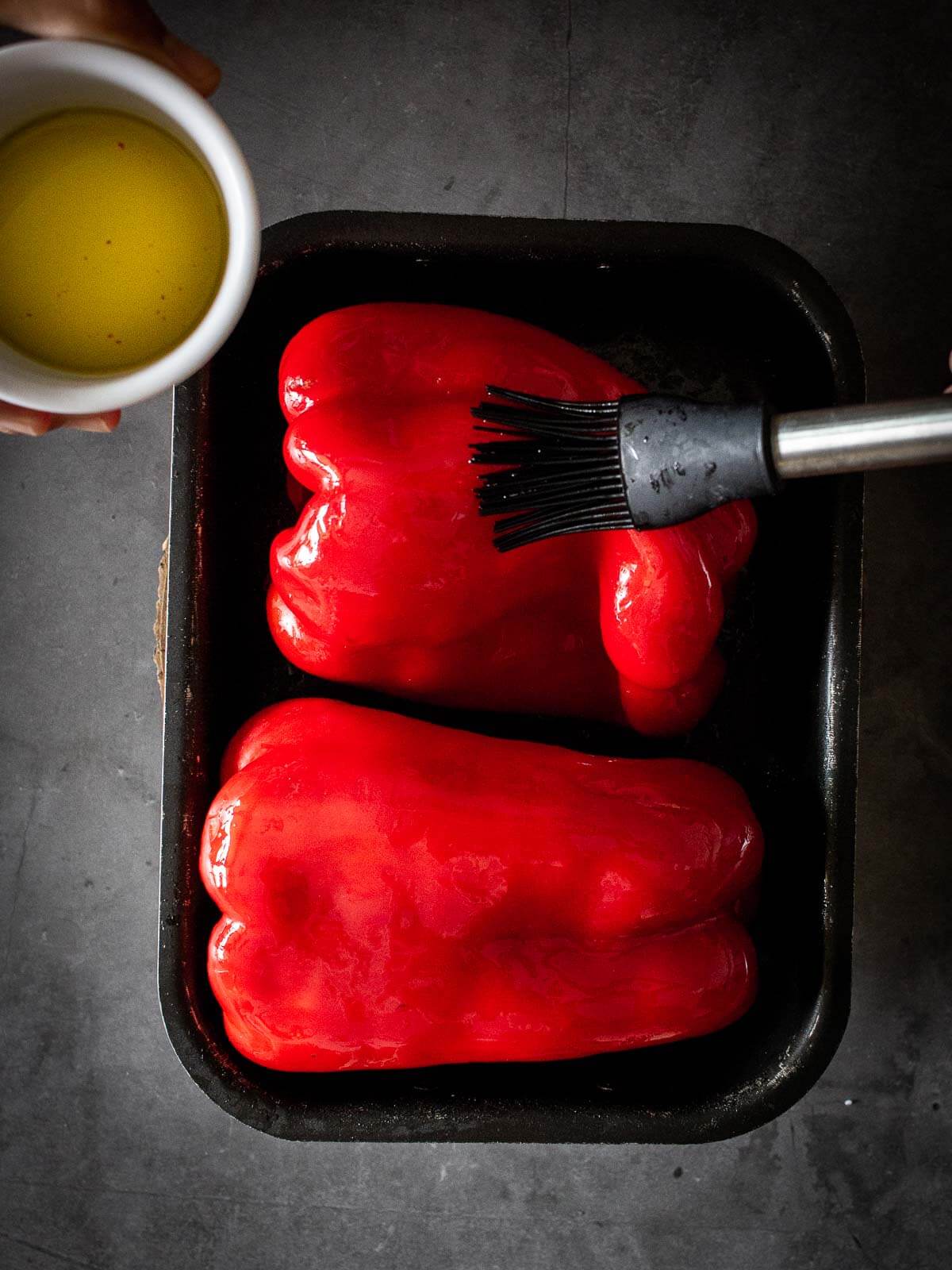 muhammara dip brushing red-bell peppers with oilve oil