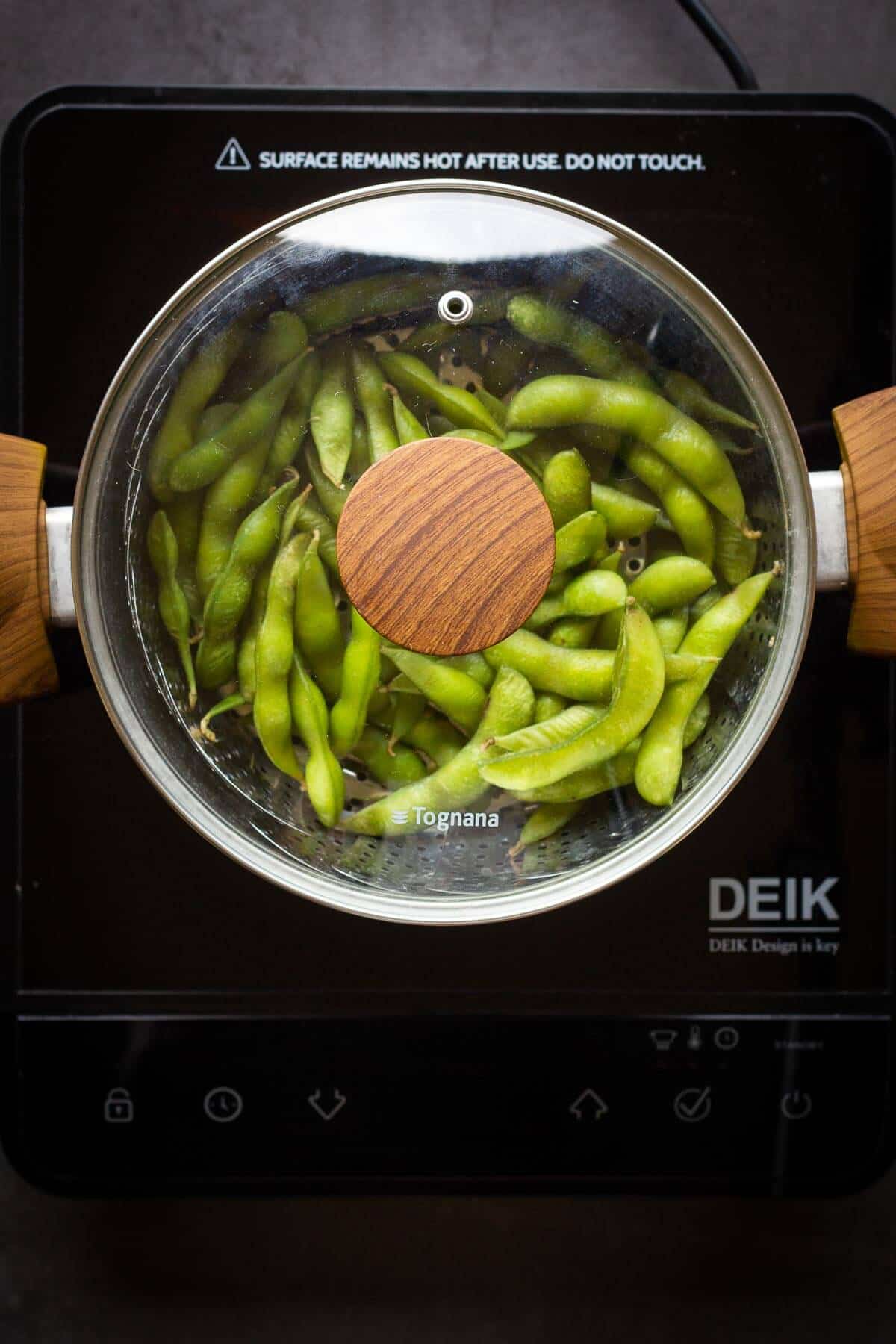 Steaming Edamame beans in a large pot.