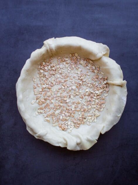 pie dough in pan with oats