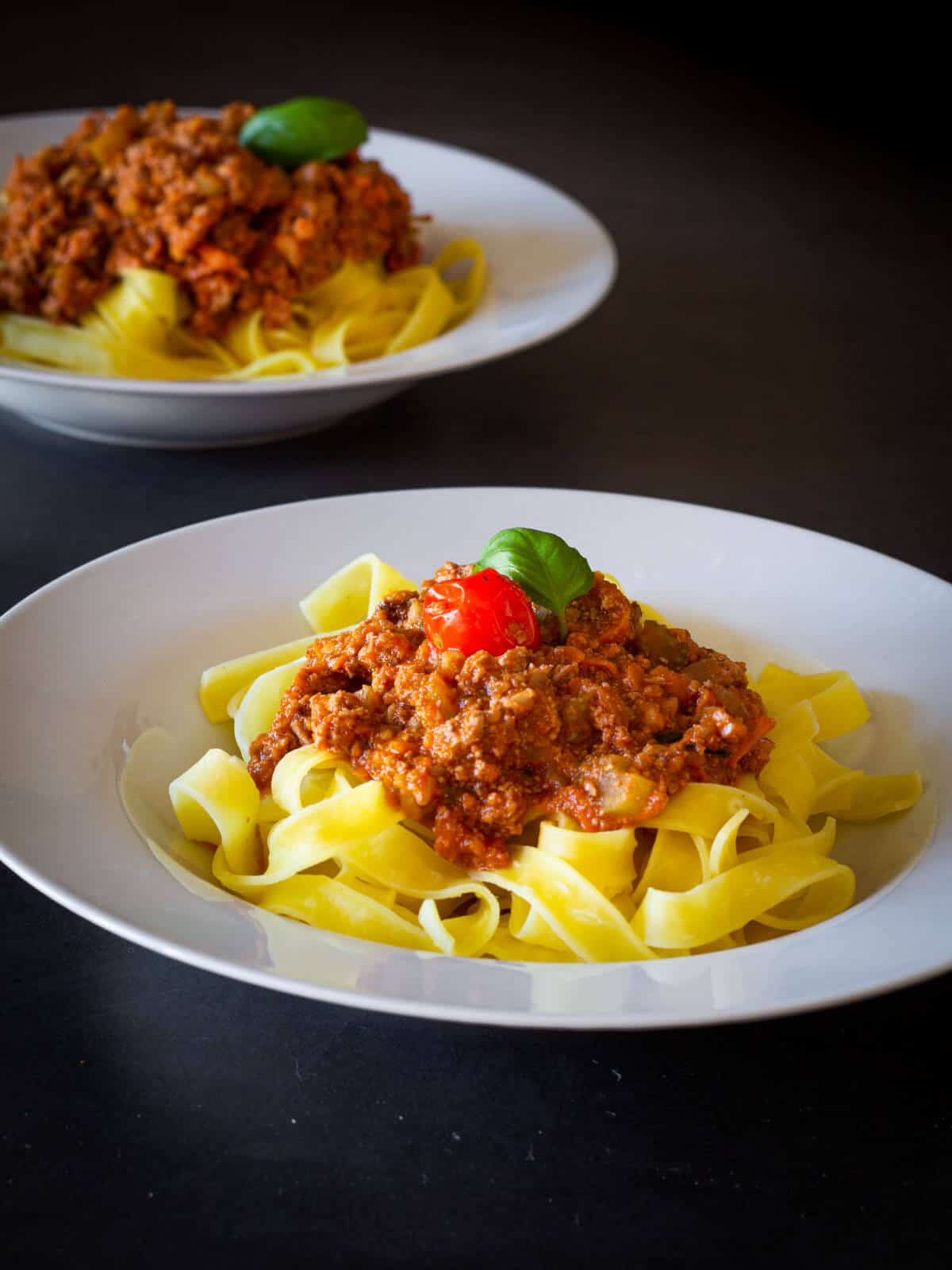 Two plates of Vegan Bolognese sauce.