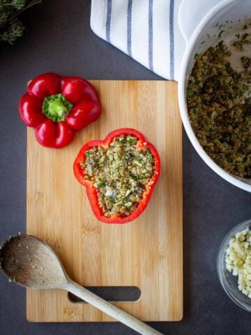 stuffing peppers with a spoon.