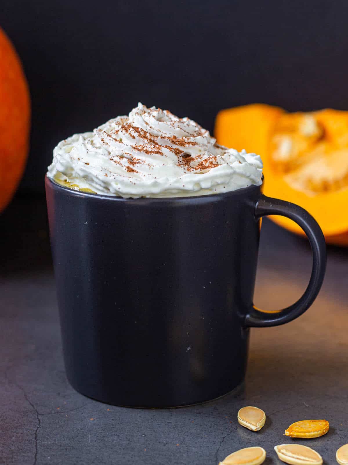 pumpkin spice latte served in mug with whipped cream