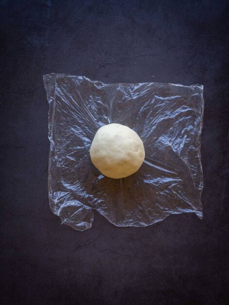 vegan no-roll-pie crust ball in plastic wrap