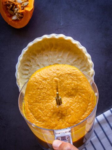pouring pumpkin pie batter into vegan no-roll pie crust