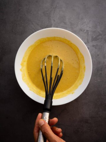 Stirring  well with a whisk until an uniform batter is achieved.