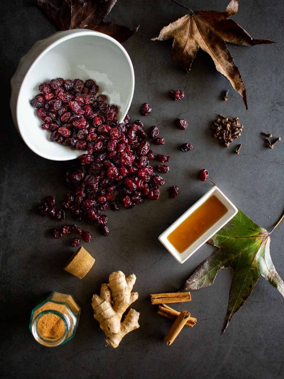 ingredients to make a spiced cranberry sauce with dried cranberries.