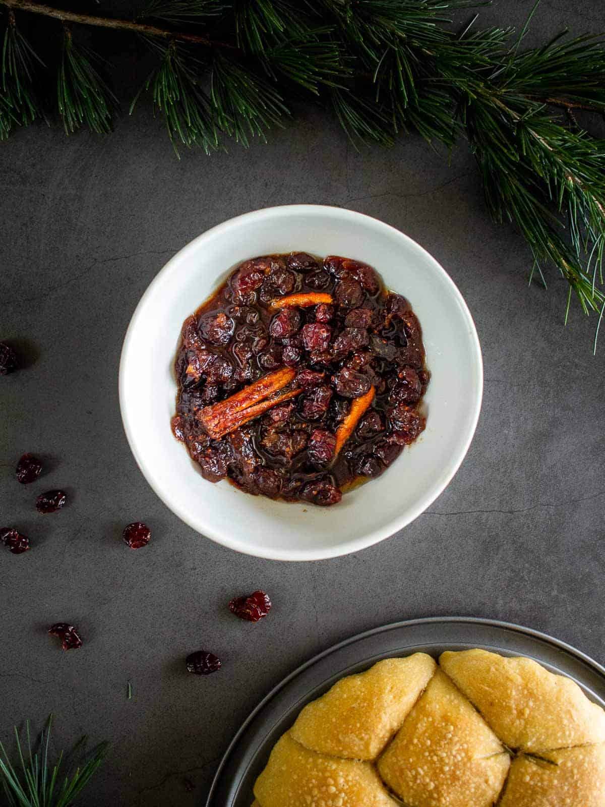 Cranberry Sauce from dried cranberries in a bowl with cinnamon sticks.