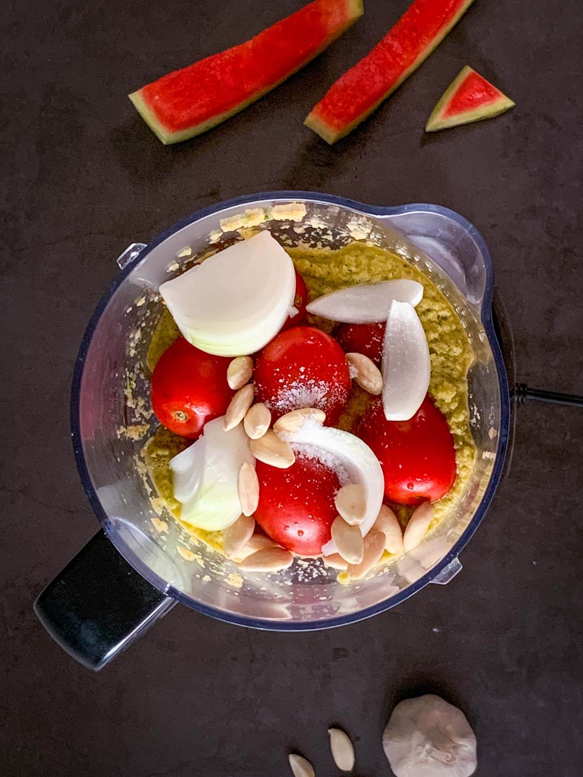 Add tomatoes almonds and garlic