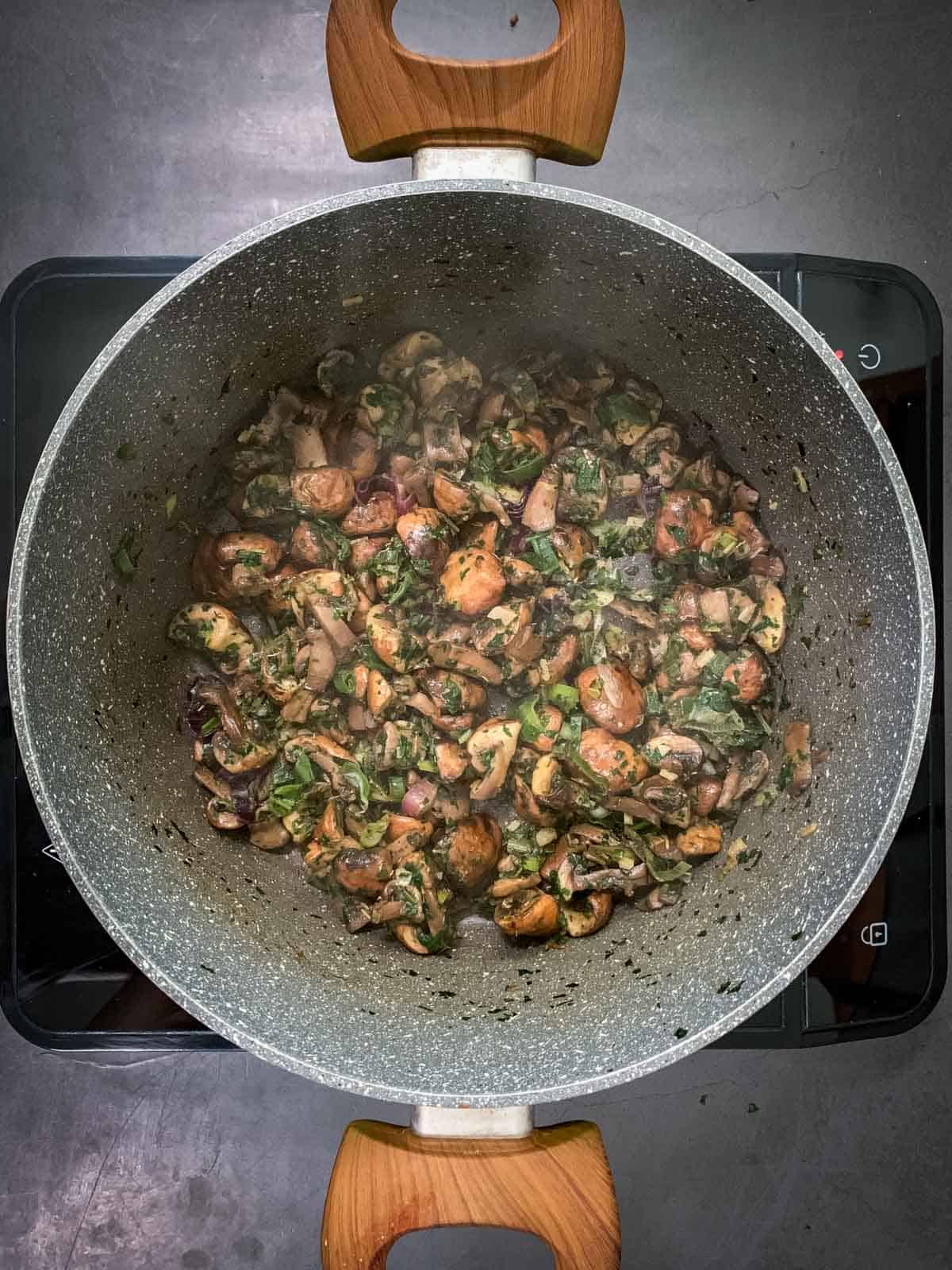 stir-frying mushroom empanadas filling in casserole.