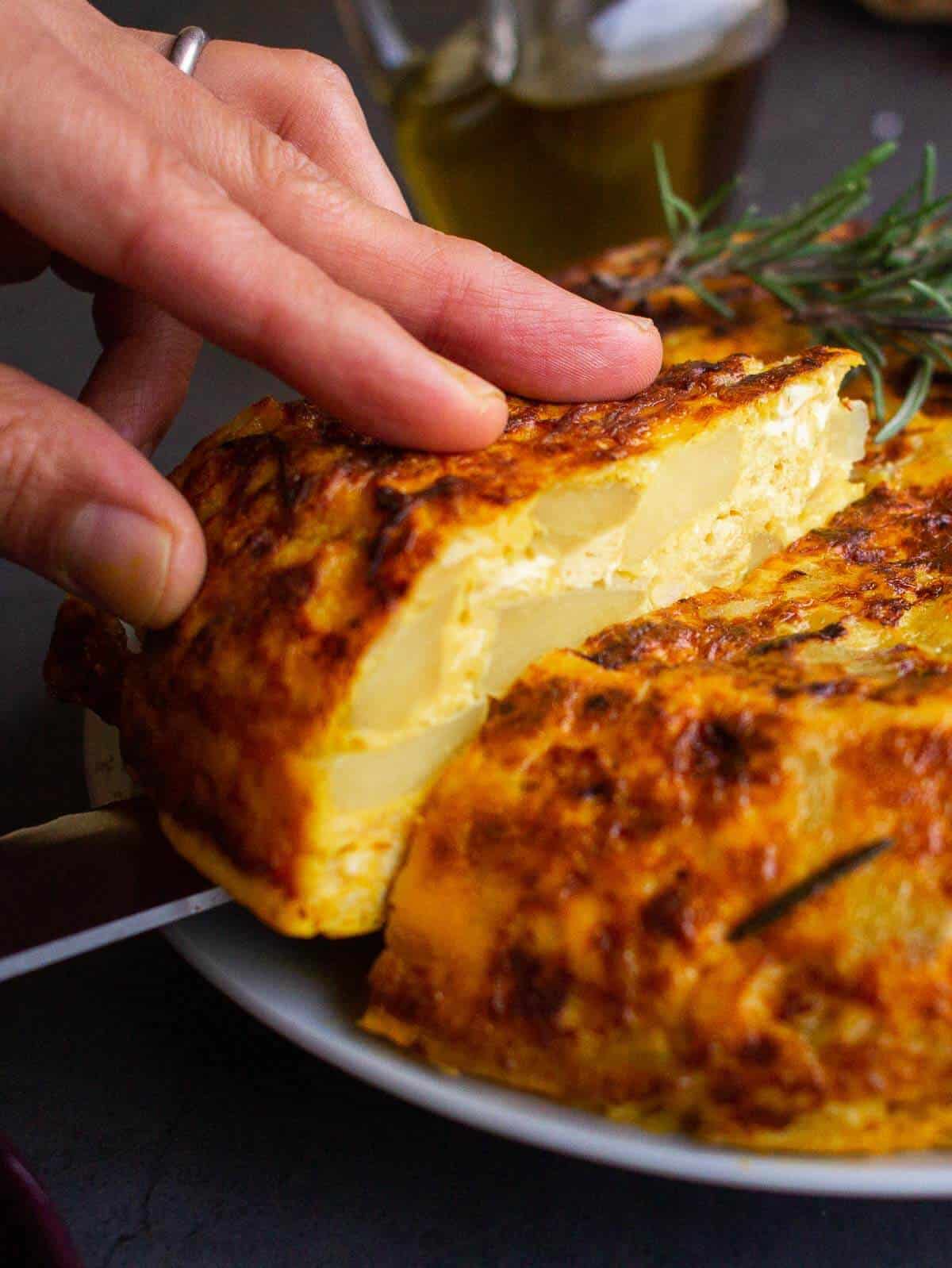 slicing the vegan Spanish tortilla.