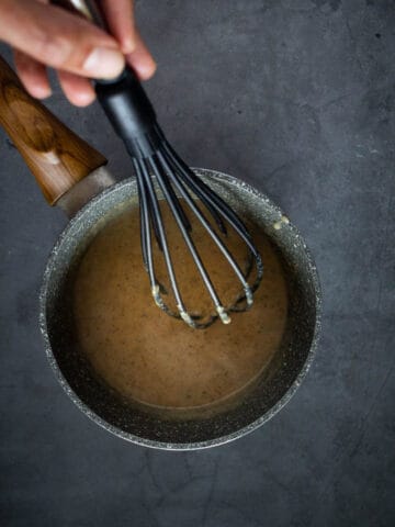 reheat mushroom gravy in a small saucepan and stir with a whisk.