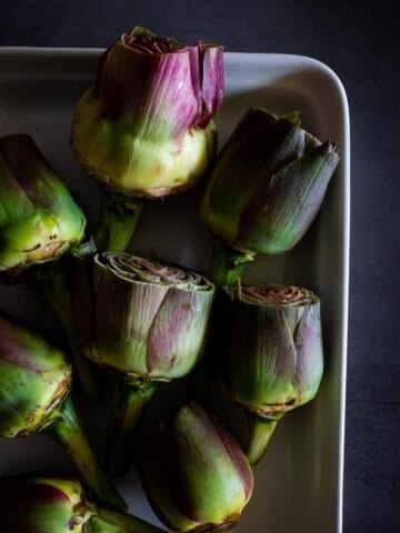cleaned artichokes with their tops trimmed.