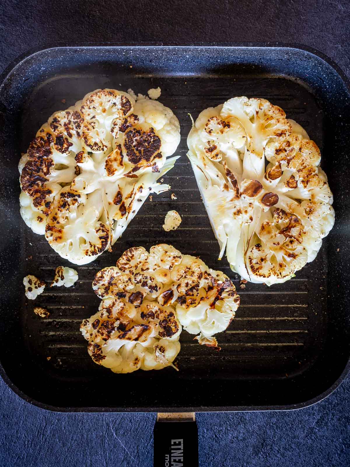 grilled cauliflower steak on grill.