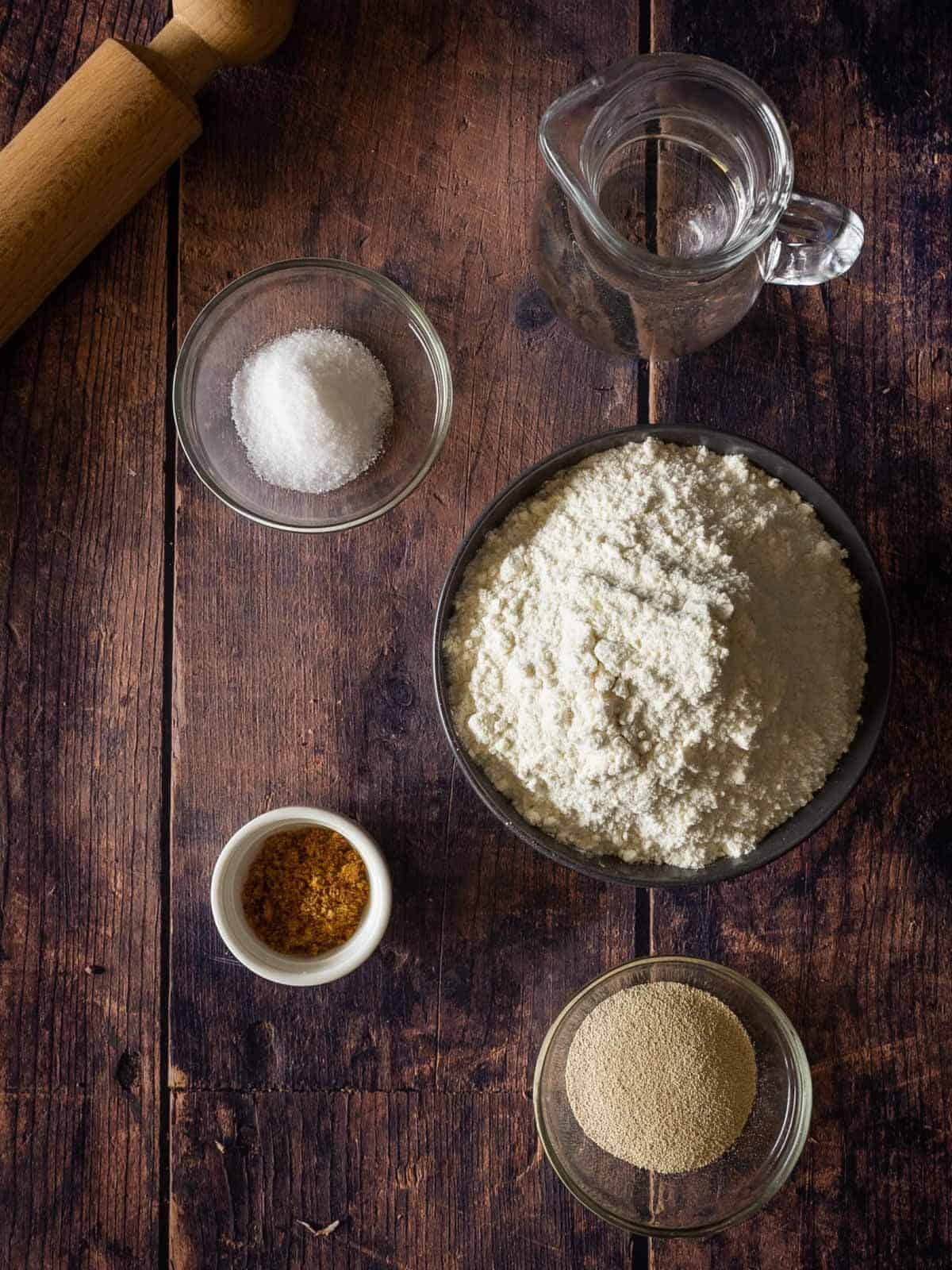 Italian artisan bread ingredients on a wooden table.