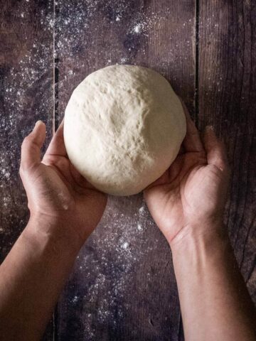 making a round shape with artisan bread