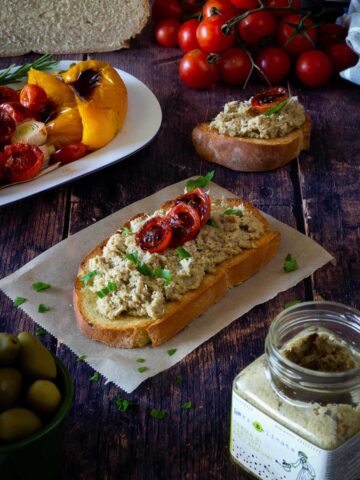 slice with artichokes spread and charred cherry tomatoes.