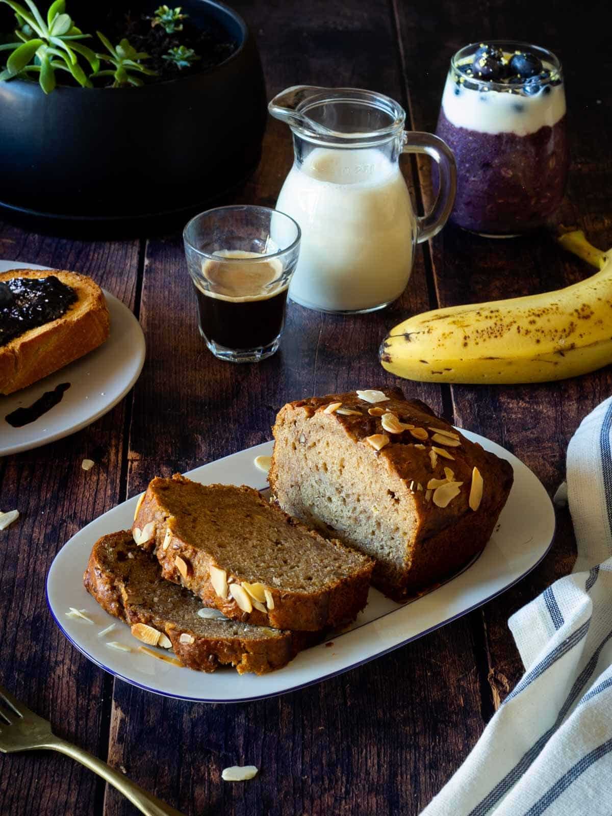 vegan banana bread in b reakfast table with coffee and blueberry toast