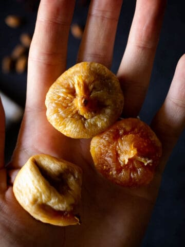 hand holding dried figs.