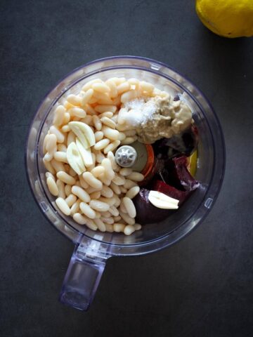 all white beans hummus inside of a blender.