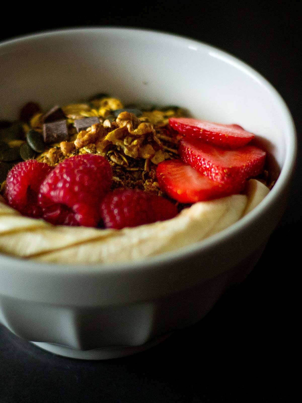 homemade granola bowl with strawberries and bananas