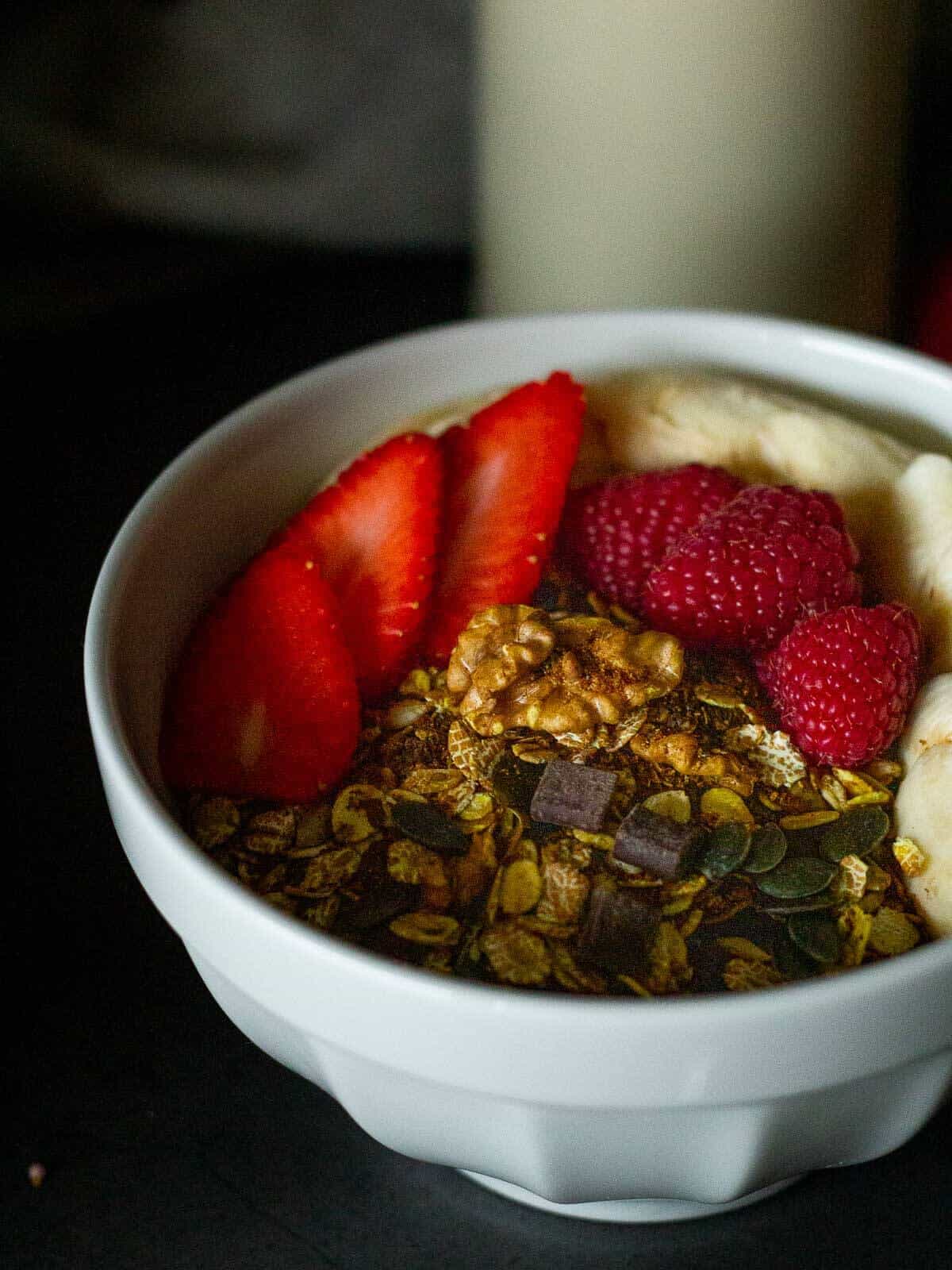 homemade granola bowl with berries and bananas