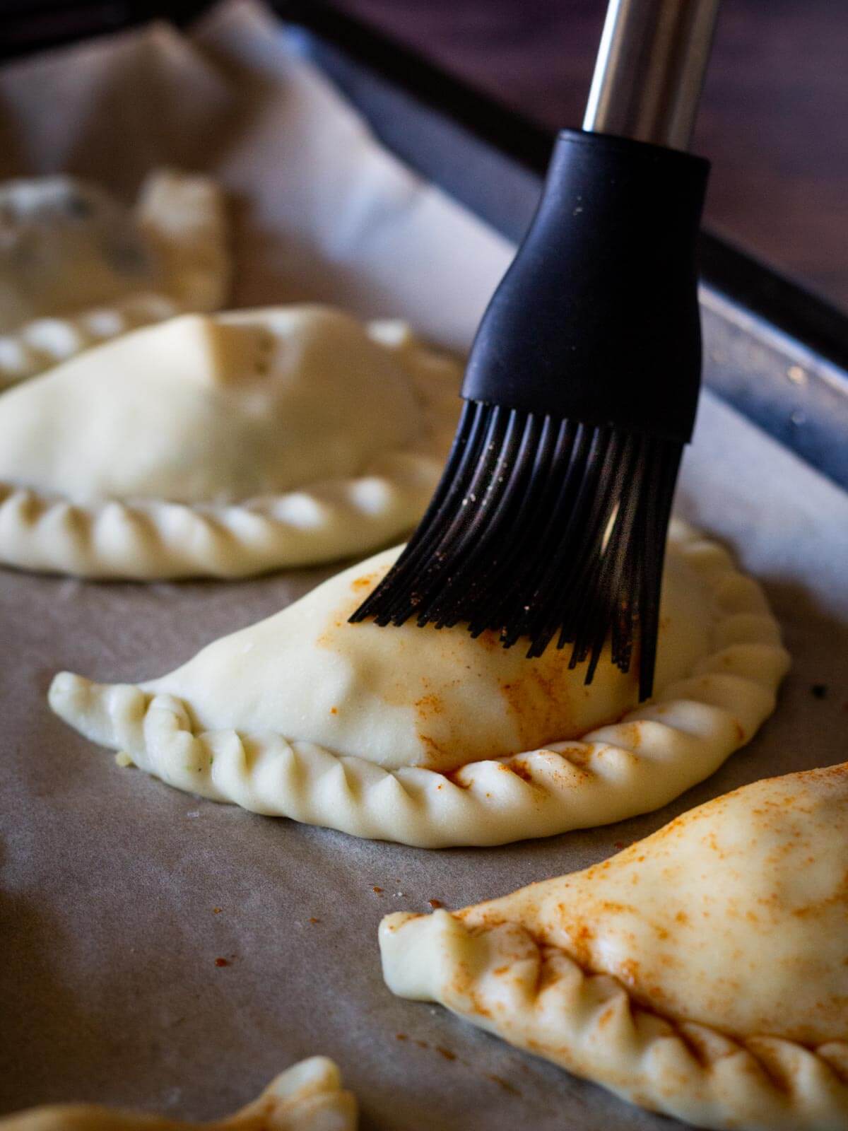 brushing turnovers with smoked paprika water mixture