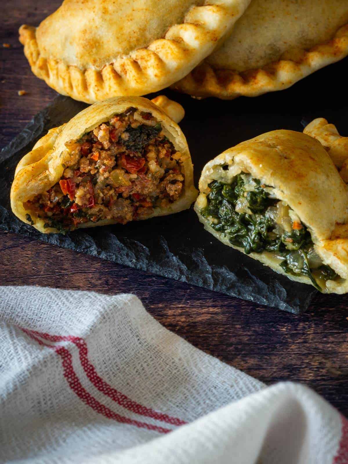 variety of baked hand-pies cut in half