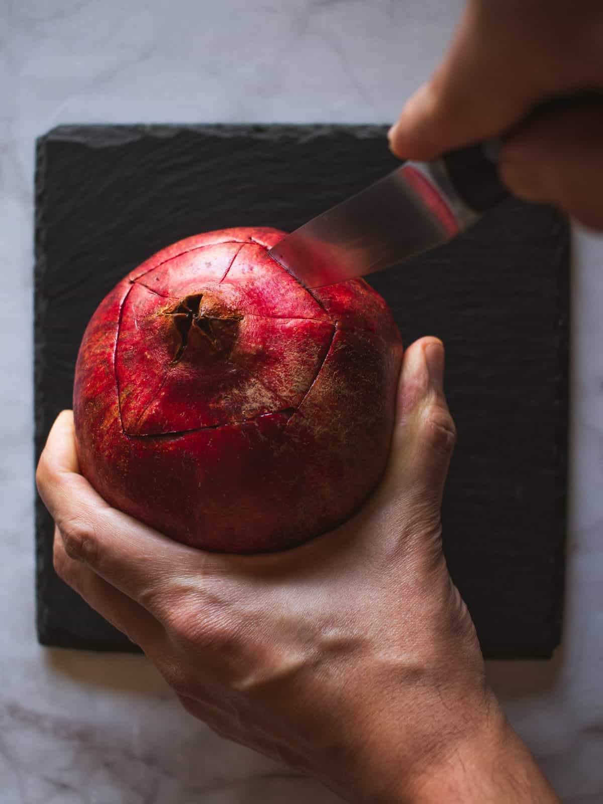 finished pentagon shaped cut on top of a pomegranate