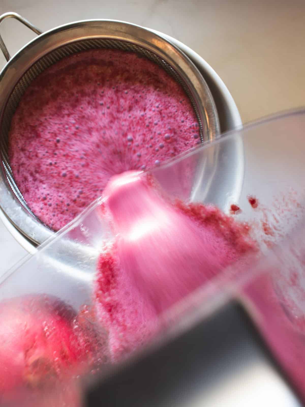 straining juice with a colander