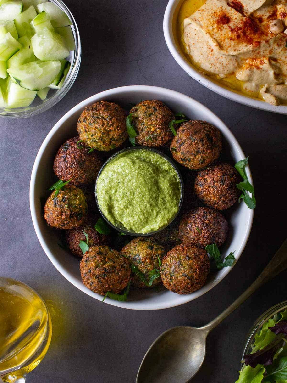 crispy vegan falafel served with Creamy Vegan Sauce and hummus.