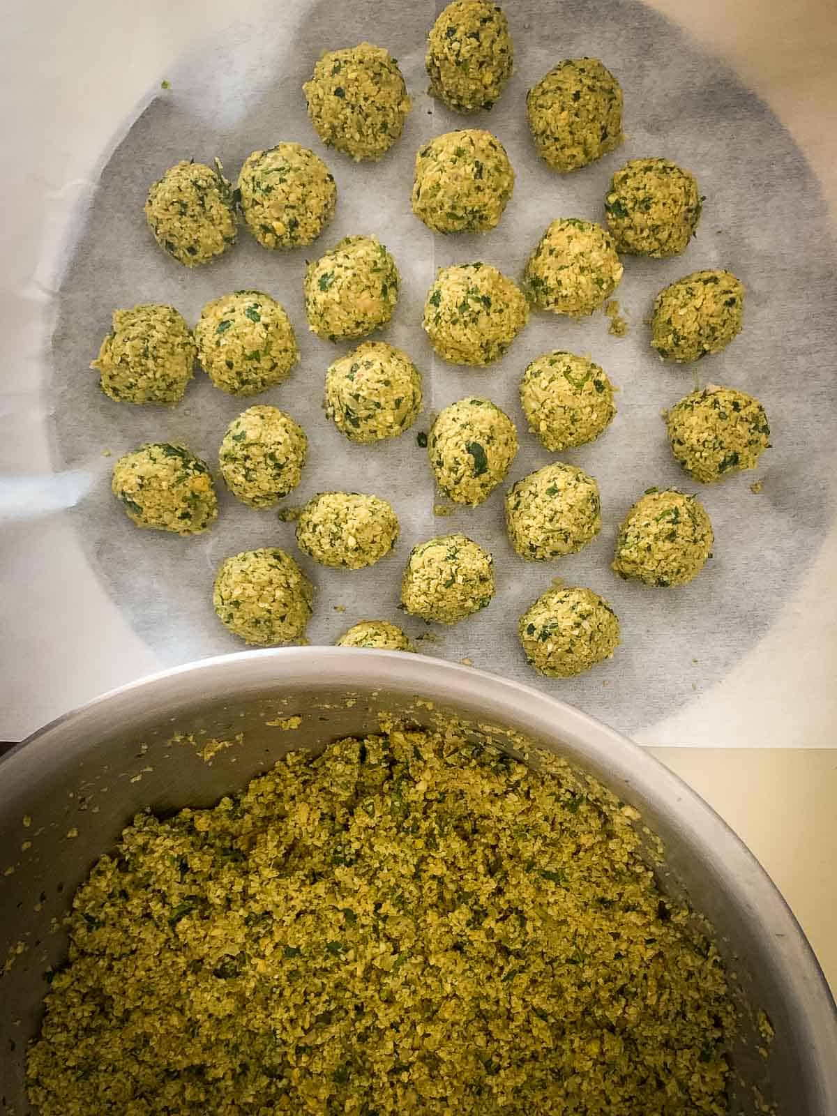 vegan falafel balls in a tray lined with parchment paper.