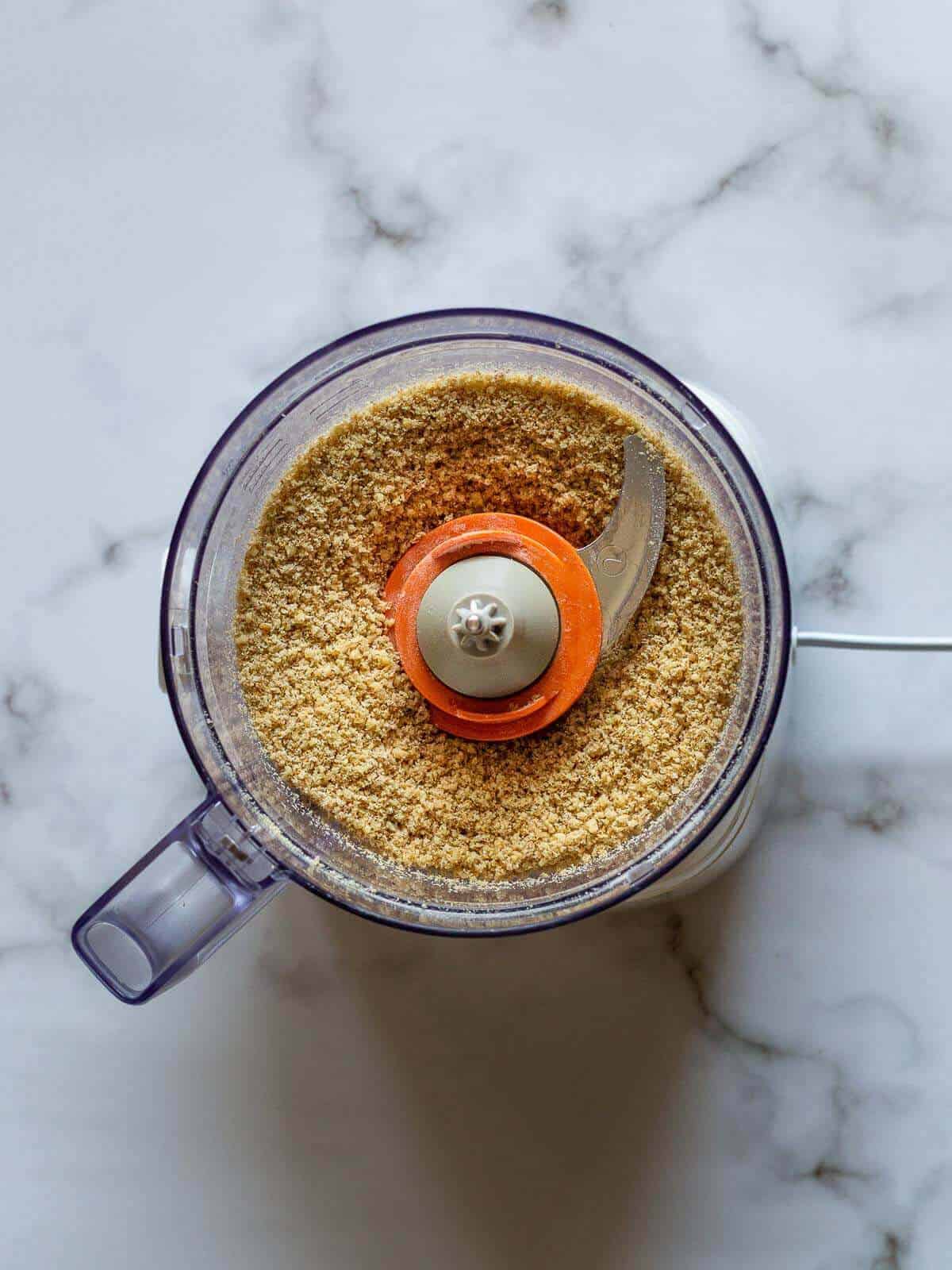 perfectly crumbly blended ingredients in blender's jar.