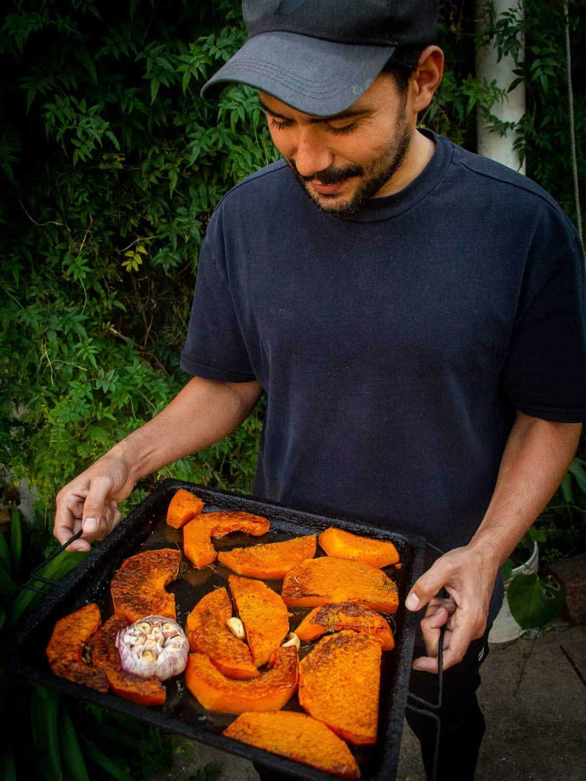 gus holding a roasted butternut squash tray