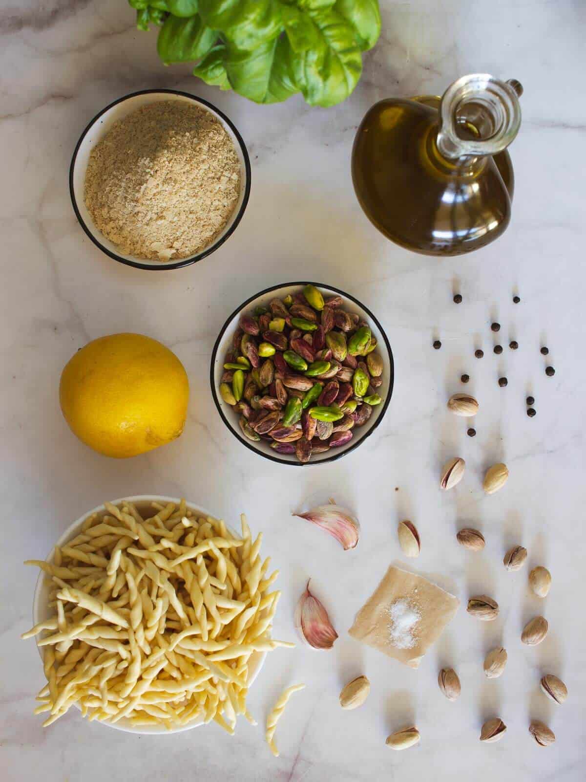 ingredients to make a vegan pesto pistachio pesto sauce