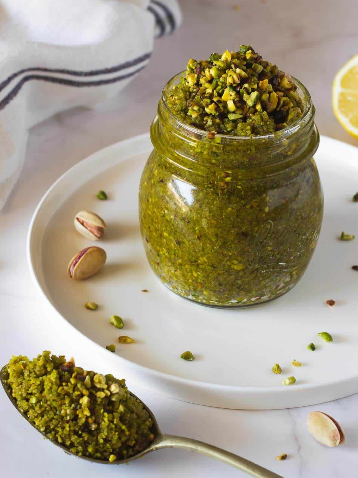 vegan pistachio pesto in airtight container HERO image