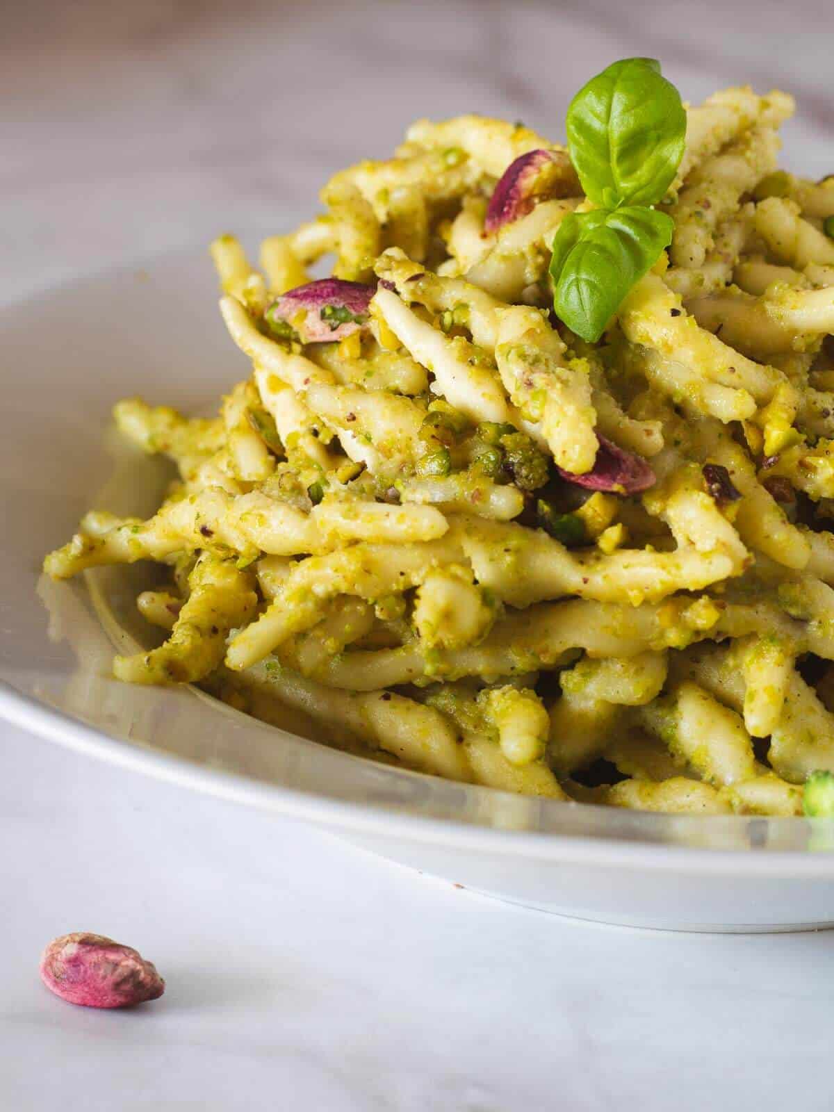 vegan pistachio pesto pasta served in a plate, close up