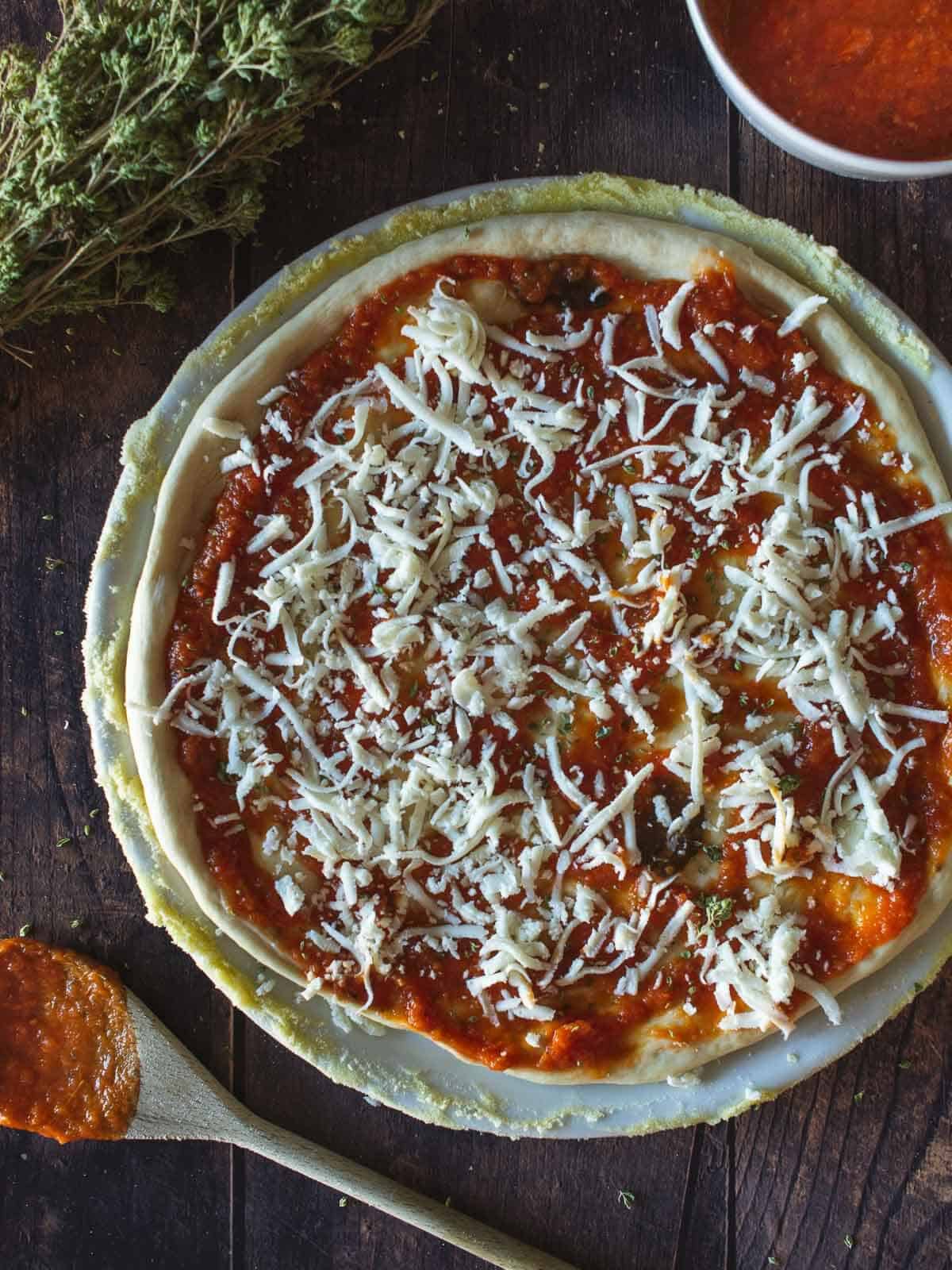 pizza margherita with shredded mozzarella.