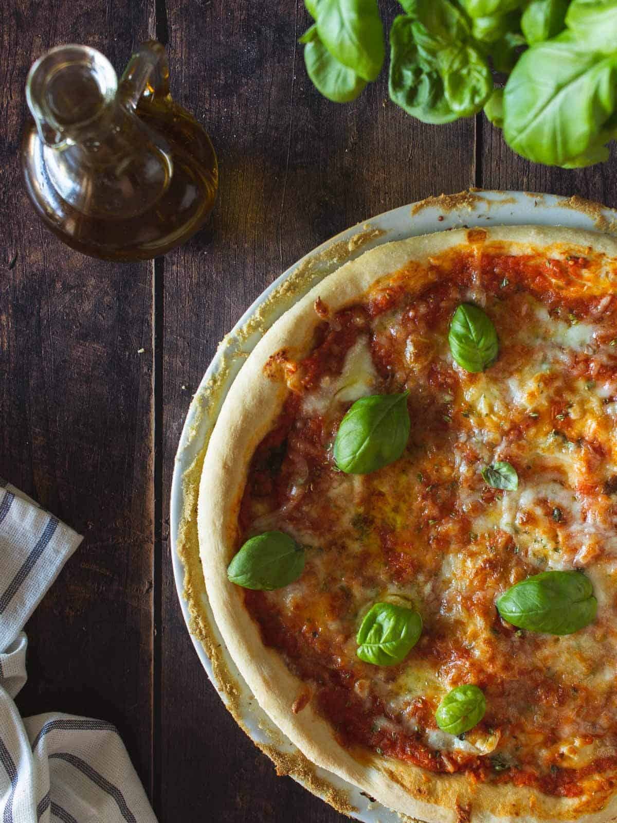 pizza made with our vegan pizza dough recipe and topped with fresh basil and vegan mozzarella.