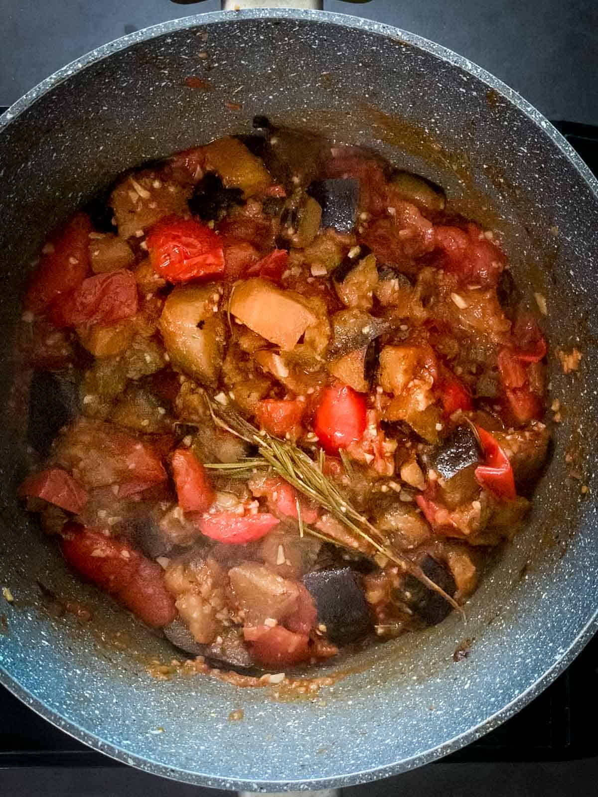 add quartered tomatoes into the saucepan.