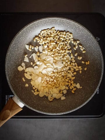 Toasting Pinenuts and almonds on a skillet.