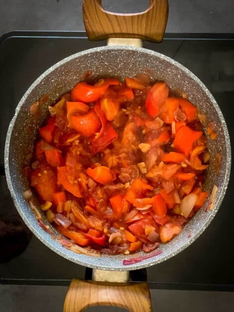 add tomatoes to vegan chili saucepan